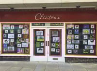School children decorate windows of empty town shop