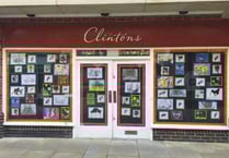 School children decorate windows of empty town shop