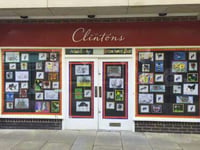 School children decorate windows of empty town shop