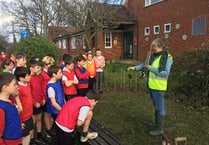 Children help out with school hedge
