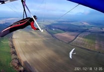 Pilot flies with a red kite over East Meon