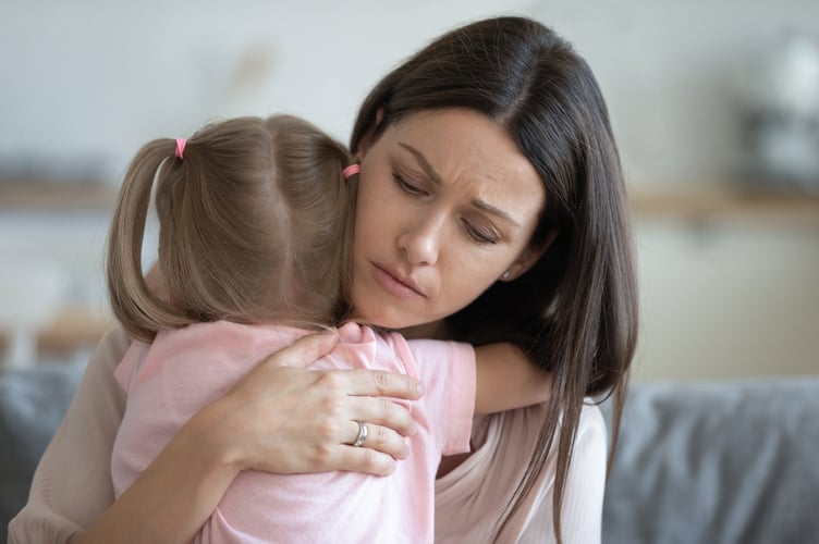 A foster carer comforting a young child