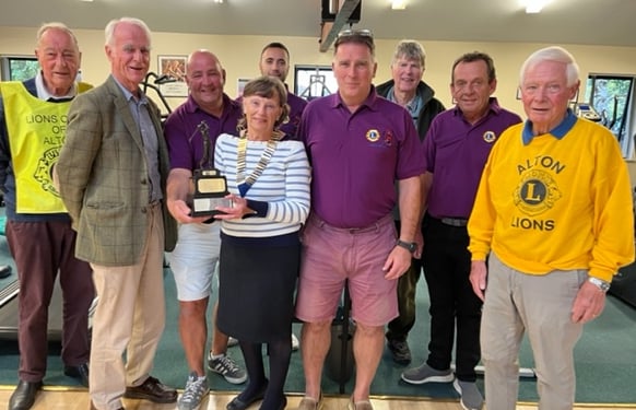 Alton Lions president Moira Baker gives the Alton Lions/Cardiac Rehab Golf Trophy to Hart Casuals, watched by Dave Crocker, Dr Hugh Bethell, John Smith and Derek Shaw, October 2022.