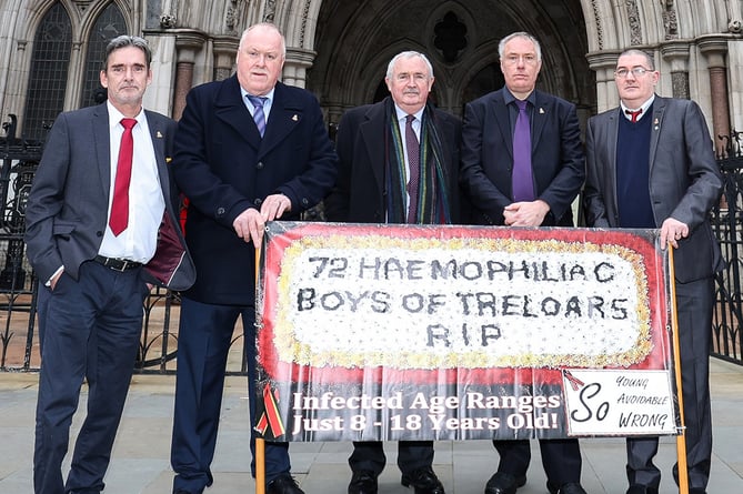 Four surviving Treloar's victims of the infected blood scandal join Des Collins, senior partner at Collins Solicitors, to make their case outside the High Court in London, January 24th 2022.