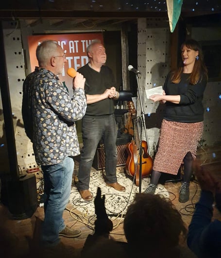Music at the Pottery co-organisers Peter Crutchfield and Jim Cozens present a cheque for £2,120 to Creative Response chief executive Kathryn McManus at The Farnham Pottery in Wrecclesham on December 17th 2022.