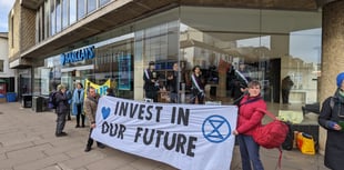 Extinction Rebellion ‘suffragettes’ chain themselves in Guildford bank