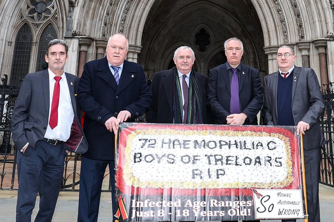 Solicitor Des Collins with Treloar's infected blood scandal survivors outside the High Court in London in January 2022.