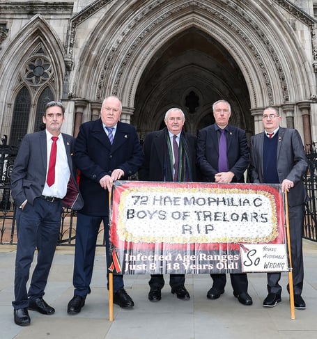 Solicitor Des Collins with Treloar's infected blood scandal survivors outside the High Court in London in January 2022.