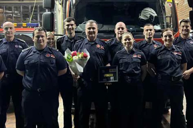 Paul Guy, with flowers, retires from Bordon fire station, February 6th 2023.