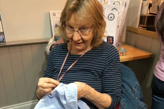 Denise Holmes repairing a pair of linen trousers at Fernhurst Hub's first repair cafe