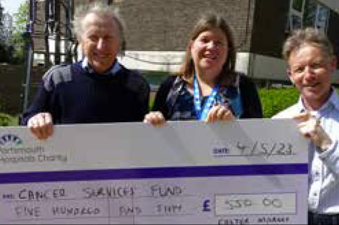 Jeremy and Martin Holmes hand over their cheque to Michelle Bowdidge, May 2023.