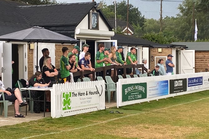 Rowledge players and supporters watch on