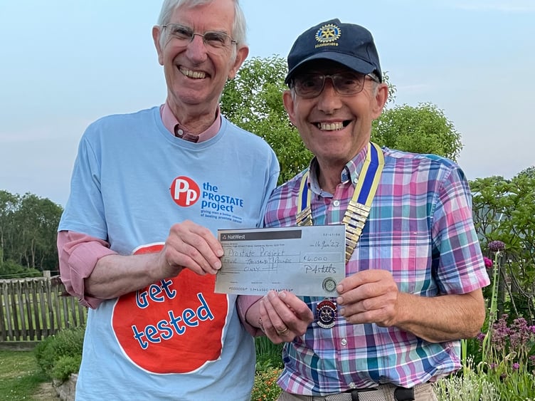 Former president of Haslemere Rotary Cub, Paul Mills, presents David Whitby from the Guildford Prostate Cancer Charity £4,000 cheque
