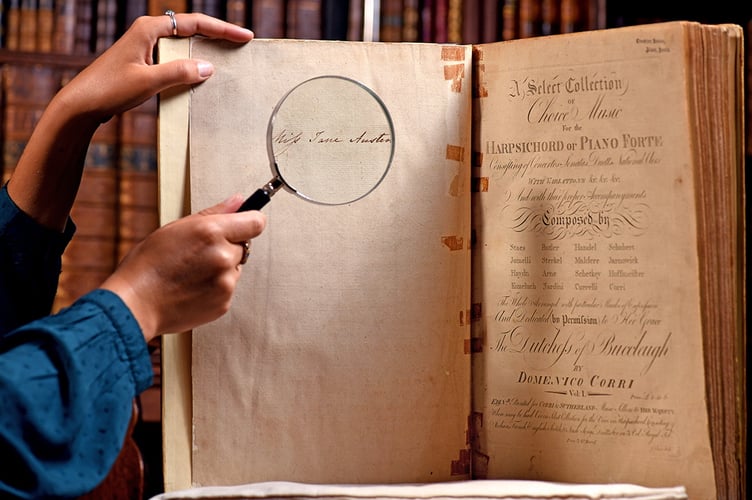 Pictured:  Clio O'Sullivan studies the music book with a magnifying glass while in the library of Chawton House, displaying Jane Austen's signature on the inside page.
Jane Austen's Music book has been discovered after it was missing for 40 years
© Simon Czapp/Solent News & Photo Agency
UK +44 (0) 2380 458800