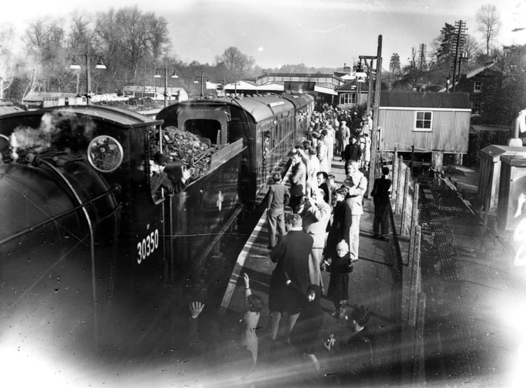 Locomotive Drummond 0-6-0 30350 pauses at Haslemere station on its way to celebrate the 100th anniversary of the 'Gosport Direct' line in 1959
