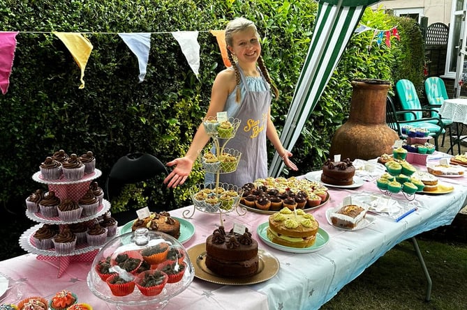 Brooke with her amazing display of cakes, baked in aid of charity Children With Cancer