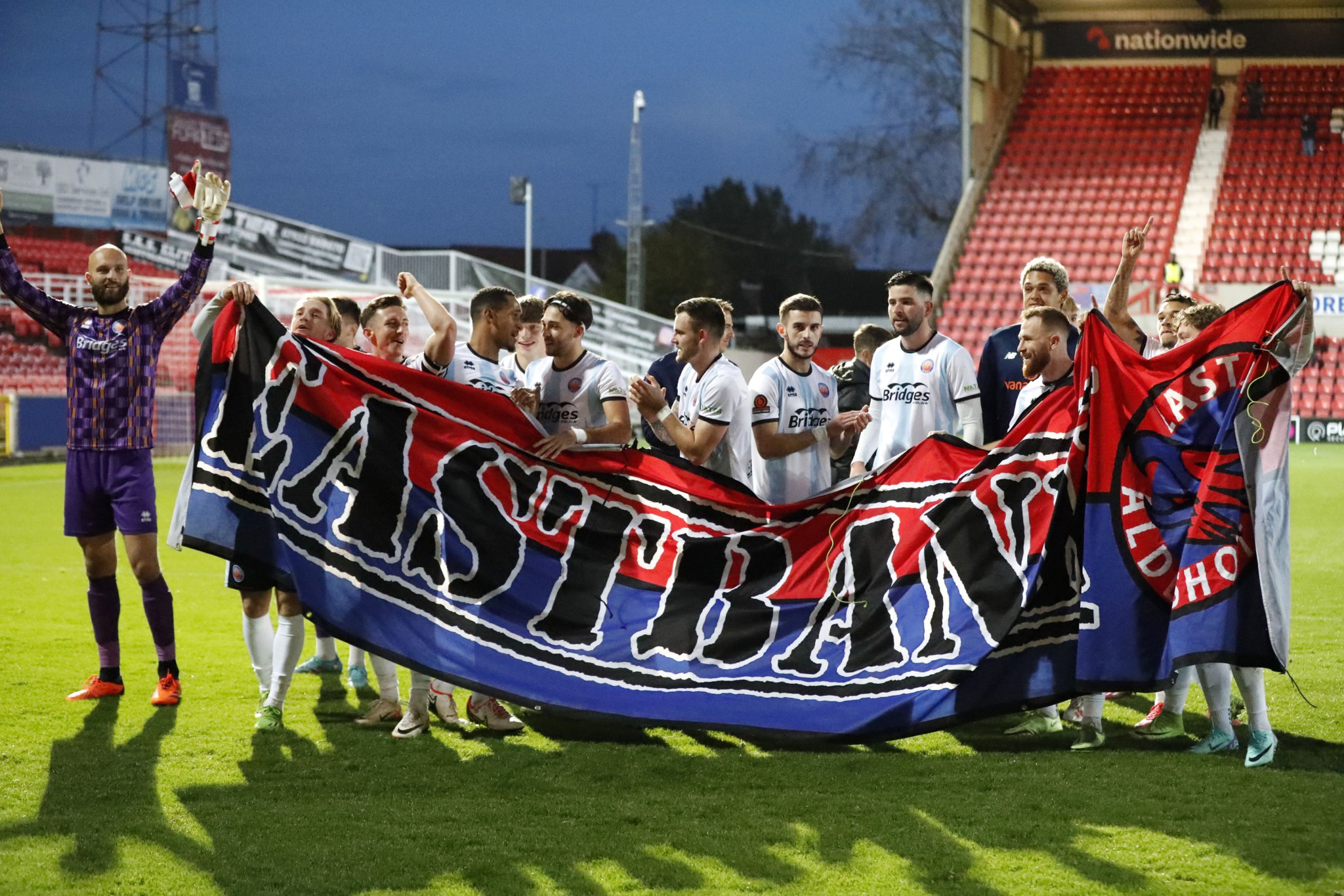 Aldershot Town’s players celebrate after beating Swindon Town 7-4