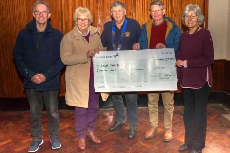 Woolmer Forest Lions acting president Richard Balchin hands over a £4,000 cheque to four local foodbanks. Pictured from left to right: Martin Firman (representing Bordon Foodbank), Pauline Firman (Headley Down Foodbank), Richard Balchin (Woolmer Forest Lions), Nigel Drury (Liss Foodbank) and Mary Braitch (Liphook Foodbank)