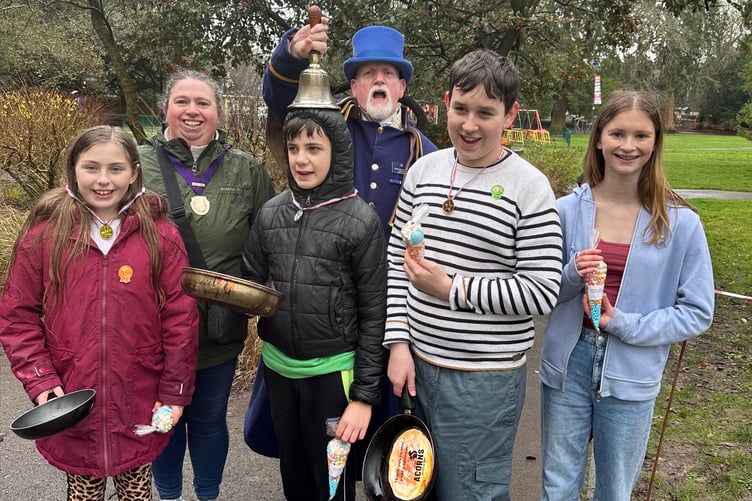 Alton Pancake Race secondary school winners Chloe, Phoebe, Dexter and Liam with Cllr Annette Eyre and town crier Dave Parsons, Public Gardens, February 13th 2024.