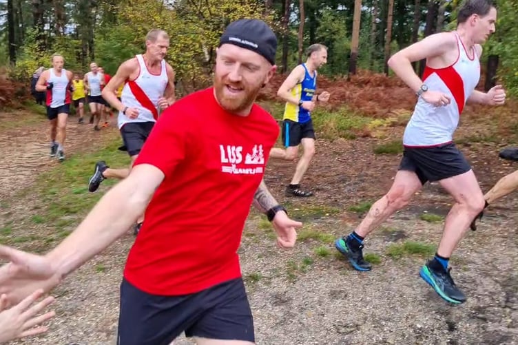 Liss Runners team captain Steve Armstrong gives a supporter a high five
