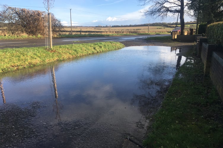 The shared strip of road outside Chalton Lane houses flooded.