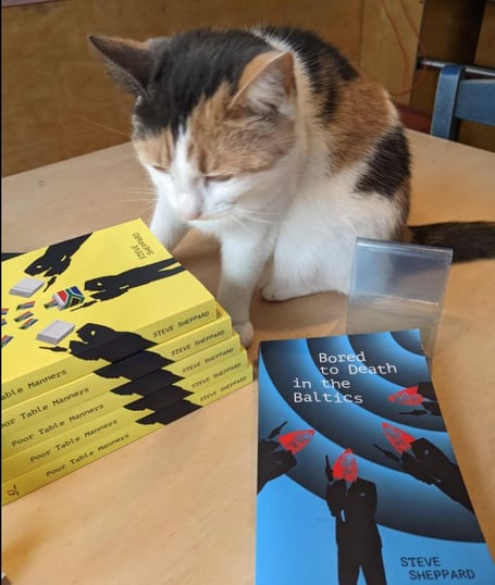 Steve's cat Charlie checking out copies of the new book
