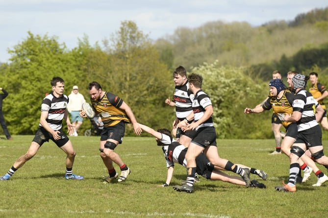 Reece Stennett prepares to tackle the Thornbury player clung to by a desperate defender (Photo: Dave Fox)