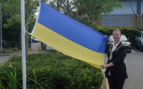Cllr Catherine Clark with the Ukraine flag at EHDC offices