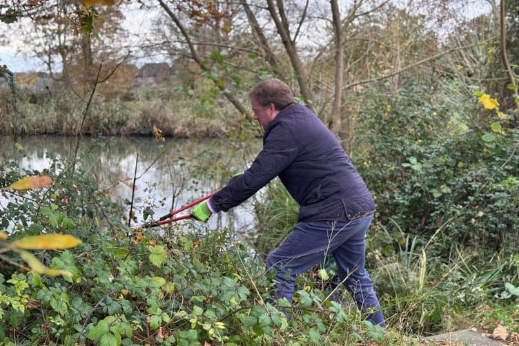 MP Greg Stafford getting stuck in to help clear Badshot Lea Pond