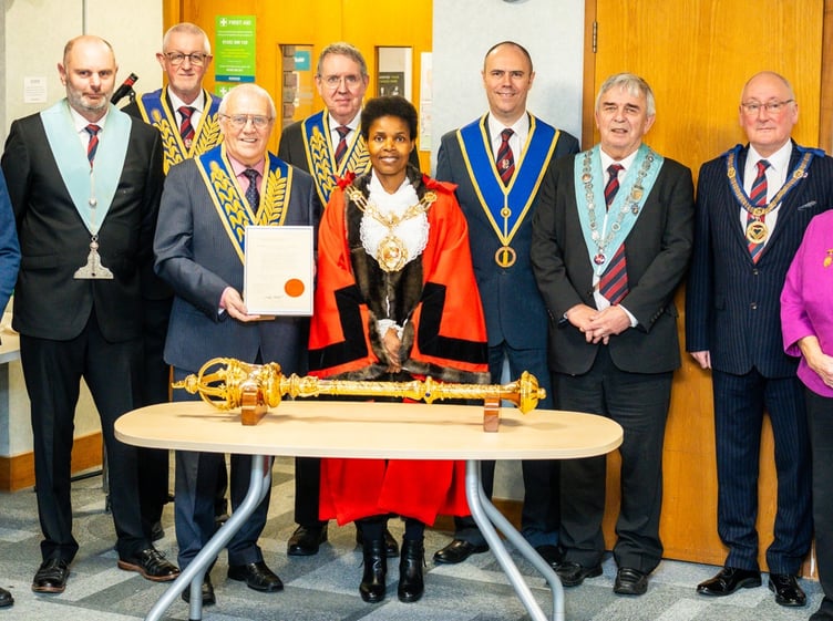 Freemasons with Rushmoor mayor Cllr Mara Makunura and the original 1924 letter of thanks for the donation of the ceremonial mace.