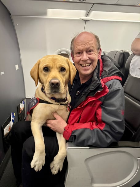 Hounds for Heroes founder Allen Parton and his assistance dog ET, aboard a British Airways Flight, their 80th one!