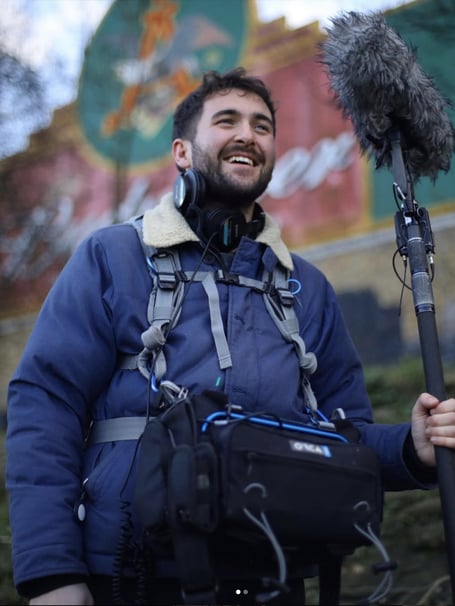 Luke on a film set with his sound equipment