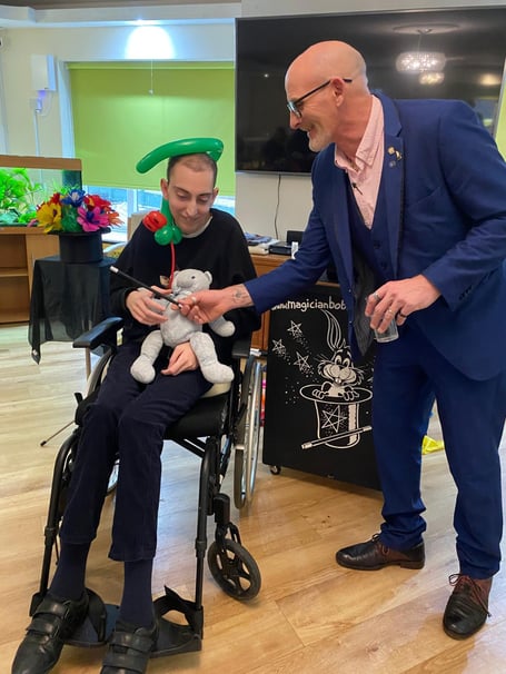 Armand Sarkissian enjoying a magician's trick at The Woodlarks Centre 