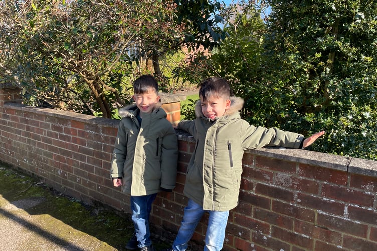 Twins Enzo and Alex enjoy the pancake race in Elstead.