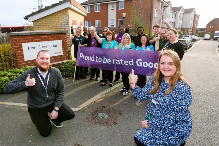 Home manager Aimee Sparks with deputy manager Adrian Ballinger (crouching) celebrating the award with the team at Pear Tree Court