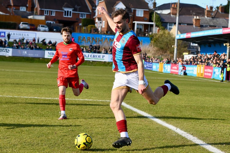 Harry Cooksley prepares to deliver a cross for Farnham