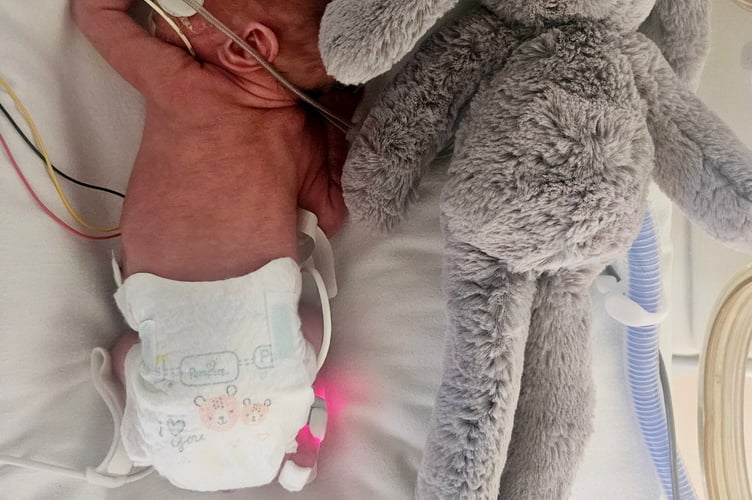Benji Sandham in hospital when first born next to his bunny toy.  A baby born at just 26 weeks who was the same size as his soft toy has made a miracle recovery - and now dwarfs his beloved bunny.  Little Benji Sandham, now 11 months old, weighed just 1lbs 14oz when he was born 14 weeks early on April 17, 2024. Benji had to have an emergency surgery at two days old to repair a hole in his bladder and spent 10 weeks in hospital, gaining his strength.   But his parents, Laura Nelson, 35, and Adam Sandham, 30, had to rush him back to hospital at four months old when his legs turned purple and his blood pressure shot up.  Investigative tests later diagnosed Benji with cerebral palsy and he is undergoing physiotherapy to help give him the best chance at mobility.  The tiny tot is still the same size as a three-month-old but is "relaxed" and "happy" and still loves his soft toy bunny. 