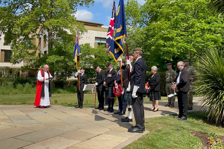 The Rt Rev Christopher Herbert leads prayers at the wreath-laying ceremony on VE Day in Farnham.