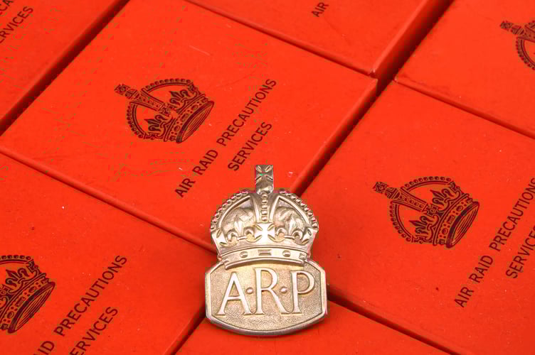 Boxes of original Air Raid Precautions badges.