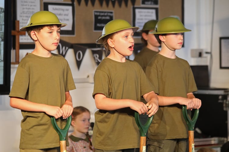 Pupils from Liphook CofE Junior School dramatize the story of Canadian involvement in two world wars for HRH the Princess Royal and invited guests.