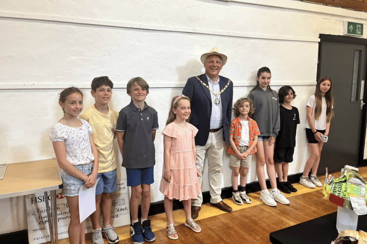 The prize winners of The Arts Society Farnham Young Arts Group's Mad as a Hatter hat making competition, with Farnham mayor Cllr George Murray, Long Kiln Gallery, Farnham Maltings, June 28th 2025.