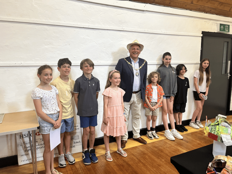 The prize winners of The Arts Society Farnham Young Arts Group's Mad as a Hatter hat making competition, with Farnham mayor Cllr George Murray, Long Kiln Gallery, Farnham Maltings, June 28th 2025.