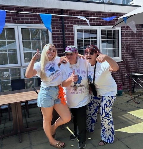 Residents and families at Downs House enjoying music and sunshine at the fundraiser for Dementia Friendly Petersfield