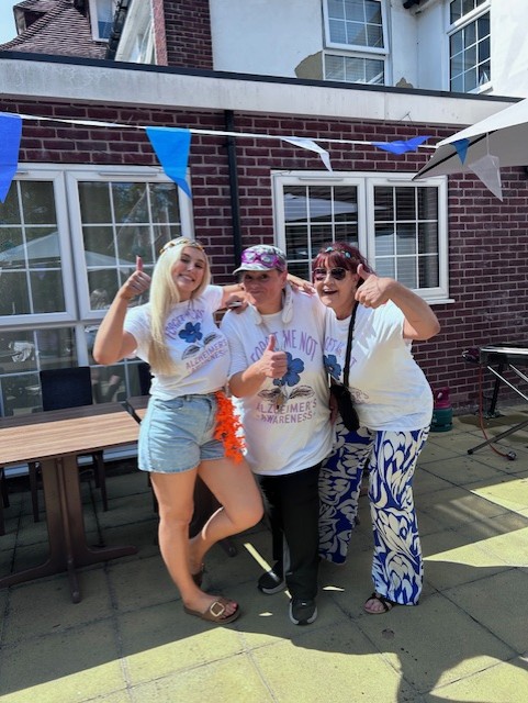 Residents and families at Downs House enjoying music and sunshine at the fundraiser for Dementia Friendly Petersfield