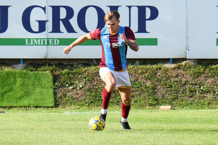 Farnham Town's Owen Dean drives forward against Sholing