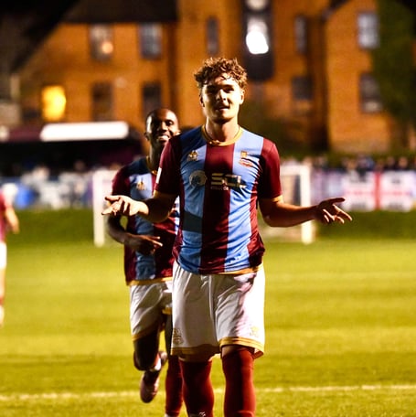 Beaux Booth celebrates after scoring on his Farnham Town debut