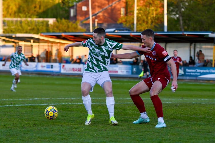Farnham Town's Darryl Sanders keeps hold of possession at Taunton