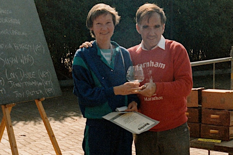 Jane Georghiou is presented with the second ladies' prize for the 1988 Farnham half marathon by former Herald editor Robin Radley