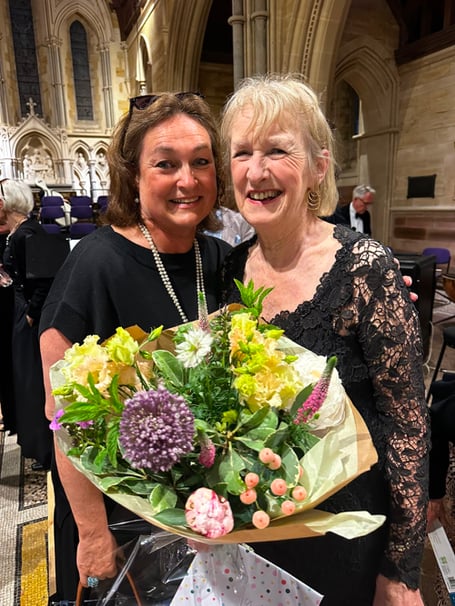 Froxfield Choir treasurer Sarah Rush, left, presents flowers to the choir's outgoing chair Sue Clegg, Holy Trinity Church, Privett, June 20th 2026.